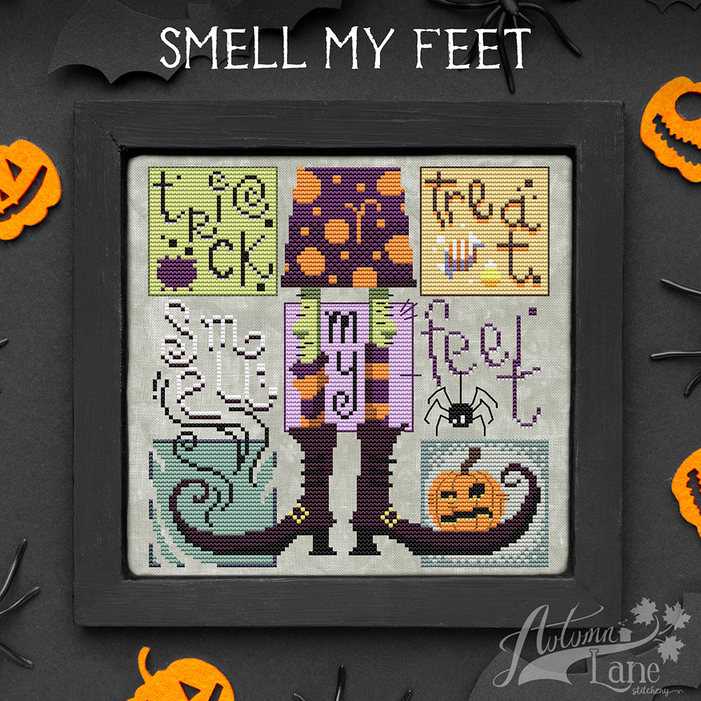 Cross stitch pattern of Trick or treat smell my feet text with candy and a spider hanging down. A pumpkin sits on a boot of a witch standing in the middle.
